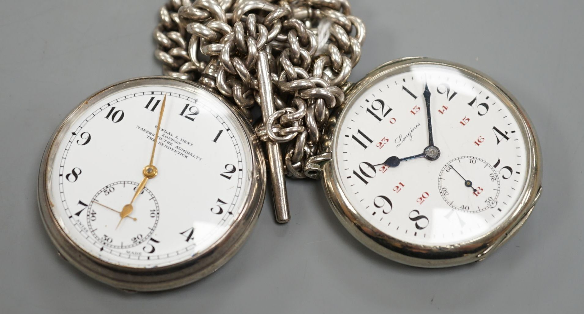 A 1930's silver open face pocket watch by Kendal & Dent and a chrome cased Longines pocket watch, both with alberts, one hallmarked silver.